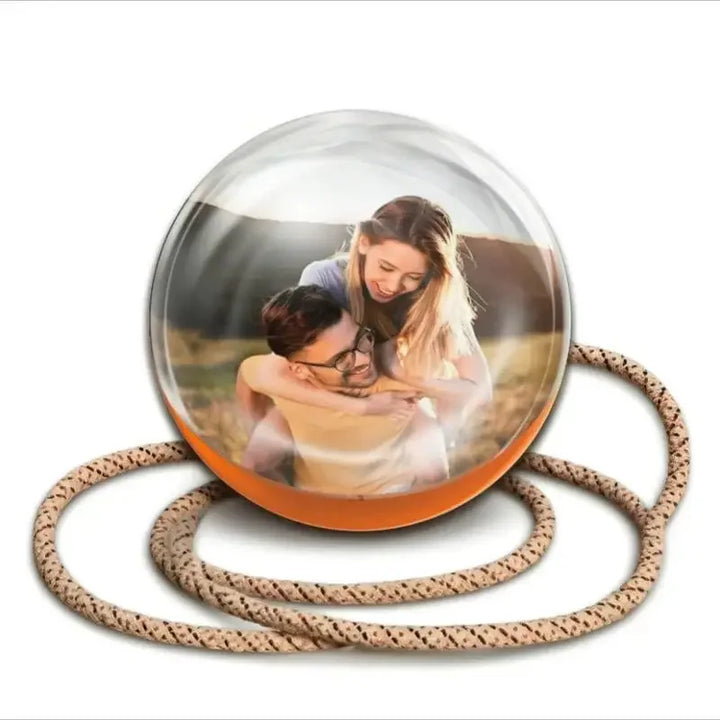 Memory Orb on its rope lanyard showing a family photo (screen image simulated)